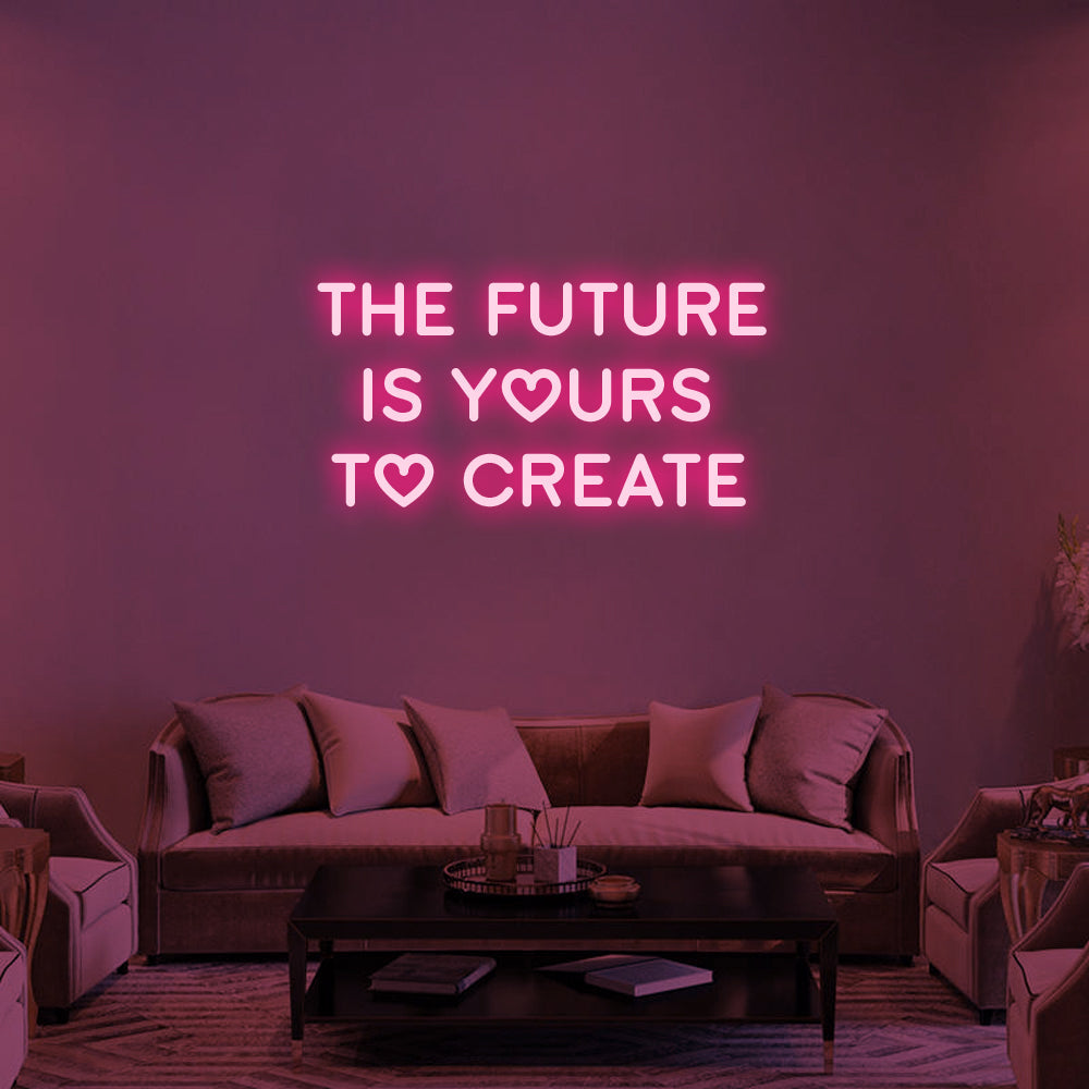 The Future Is Yours to Create LED neon quote glowing pink above a sofa