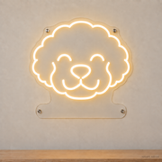 MEON NEON-watermarked concept mockup of a Warm White Bichon Frise head LED neon sign with a blank acrylic area for a UV-printed breed caption or dog name.