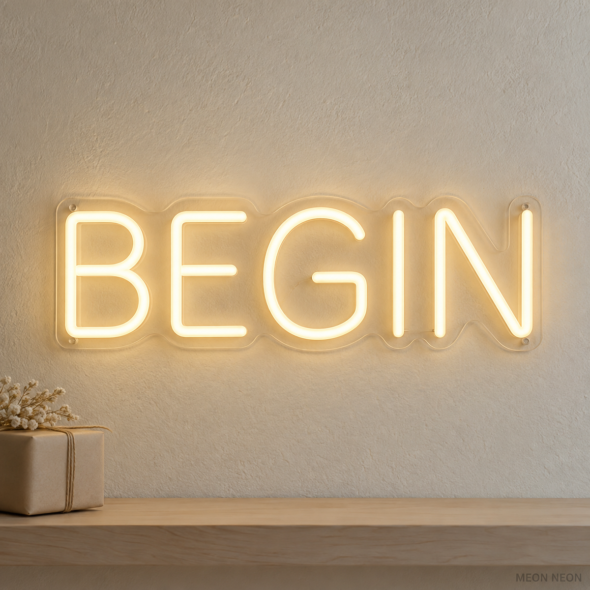 Watermarked concept mockup of the Mini Begin LED Neon Sign in Warm White on a clear acrylic backboard.