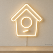 Watermarked concept mockup of Mini Birdhouse LED Neon Sign in Warm White on a clear acrylic backboard.