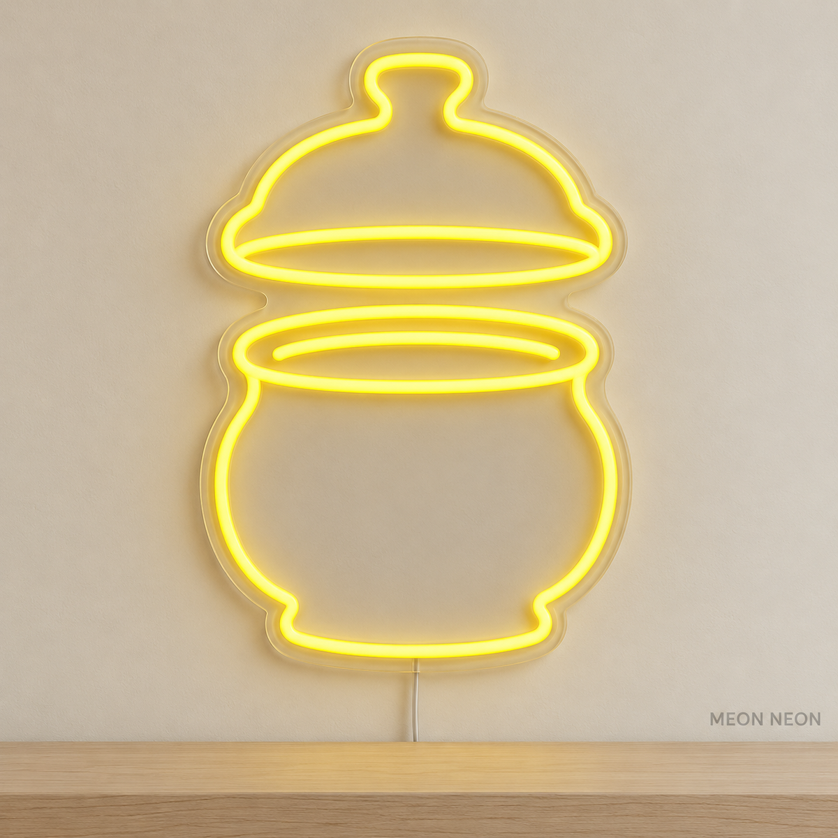 Watermarked concept mockup of Mini Butter Bell LED Neon Sign in Yellow on a clear acrylic backboard.