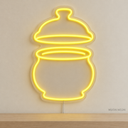 Watermarked concept mockup of Mini Butter Bell LED Neon Sign in Yellow on a clear acrylic backboard.