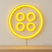 Watermarked concept mockup of Mini Button LED Neon Sign in Yellow on a clear acrylic backboard.
