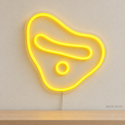 Watermarked concept mockup of Mini Climbing Hold LED Neon Sign in Yellow on a clear acrylic backboard.