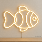 Watermarked concept mockup of Mini Clownfish LED Neon Sign in Warm White on a clear acrylic backboard.