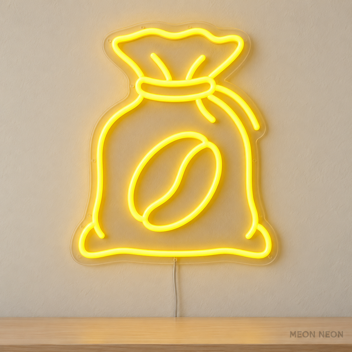 Watermarked concept mockup of Mini Coffee Sack LED Neon Sign in Yellow on a clear acrylic backboard.