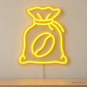 Watermarked concept mockup of Mini Coffee Sack LED Neon Sign in Yellow on a clear acrylic backboard.