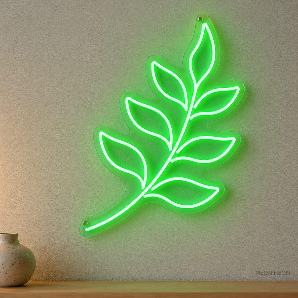 Watermarked concept mockup of Mini Fern Frond LED Neon Sign in Green on a clear acrylic backboard.