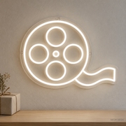 Watermarked concept mockup of the Mini Film Reel LED Neon Sign in White on a clear acrylic backboard.