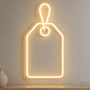 Watermarked concept mockup of Mini Gift Tag LED Neon Sign in Warm White on a clear acrylic backboard.