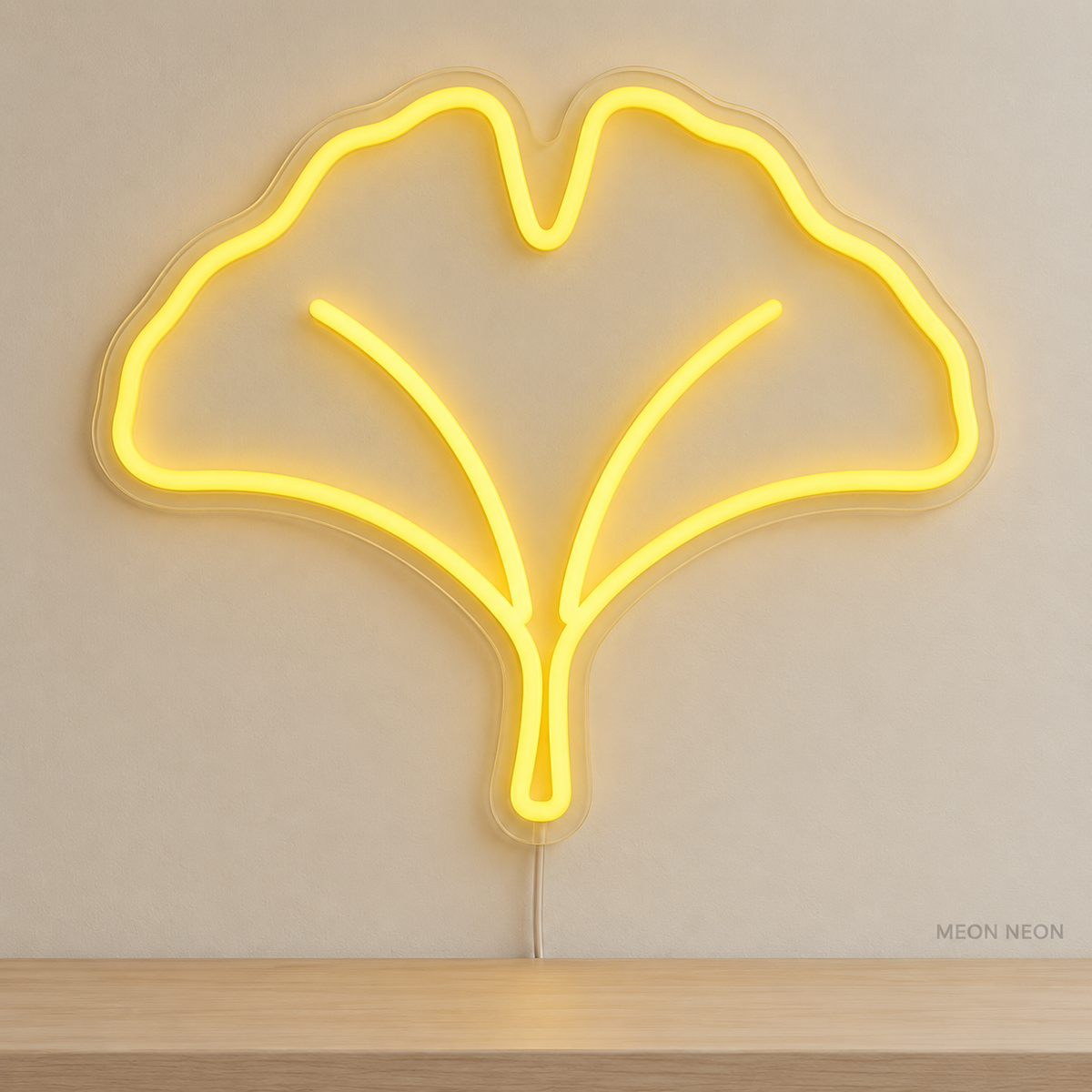 Watermarked concept mockup of Mini Ginkgo Leaf LED Neon Sign in Yellow on a clear acrylic backboard.