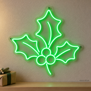 Watermarked concept mockup of the Mini Holly Sprig LED Neon Sign in Green on a clear acrylic backboard.