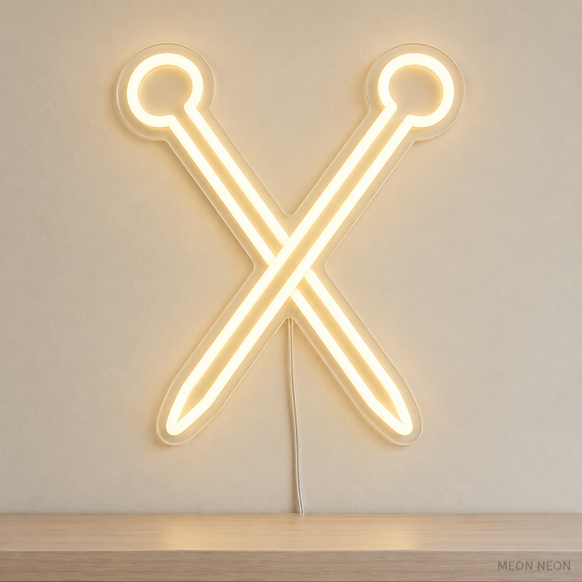 Watermarked concept mockup of Mini Knitting Needles LED Neon Sign in Warm White on a clear acrylic backboard.