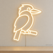Watermarked concept mockup of Mini Kookaburra LED Neon Sign in Warm White on a clear acrylic backboard.