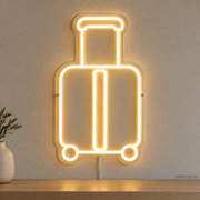 Watermarked concept mockup of Mini Luggage LED Neon Sign in Warm White on a clear acrylic backboard.
