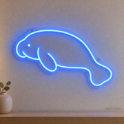 Watermarked concept mockup of Mini Manatee LED Neon Sign in Blue on a clear acrylic backboard.