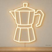 Watermarked concept mockup of Mini Moka Pot LED Neon Sign in Warm White on a clear acrylic backboard.