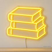 Watermarked concept mockup of Mini Notebook Stack LED Neon Sign in Yellow on a clear acrylic backboard.