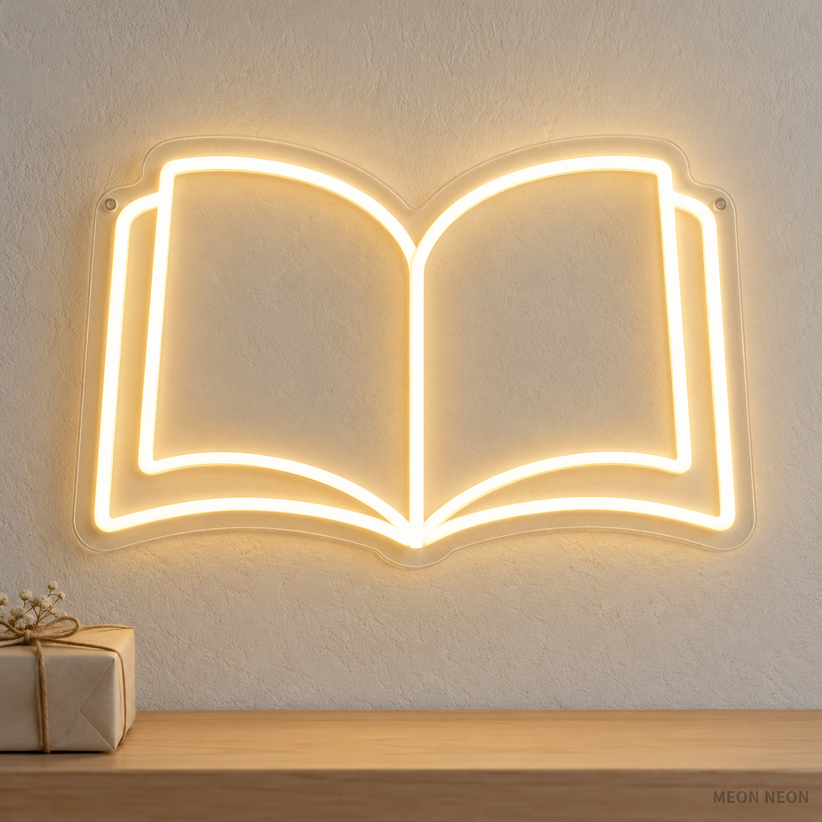 Watermarked concept mockup of the Mini Open Book LED Neon Sign in Warm White on a clear acrylic backboard.