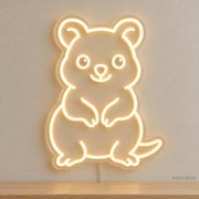 Watermarked concept mockup of Mini Quokka LED Neon Sign in Warm White on a clear acrylic backboard.