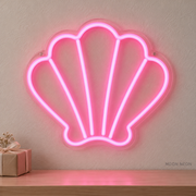 Watermarked concept mockup of the Mini Seashell LED Neon Sign in Pink on a clear acrylic backboard.