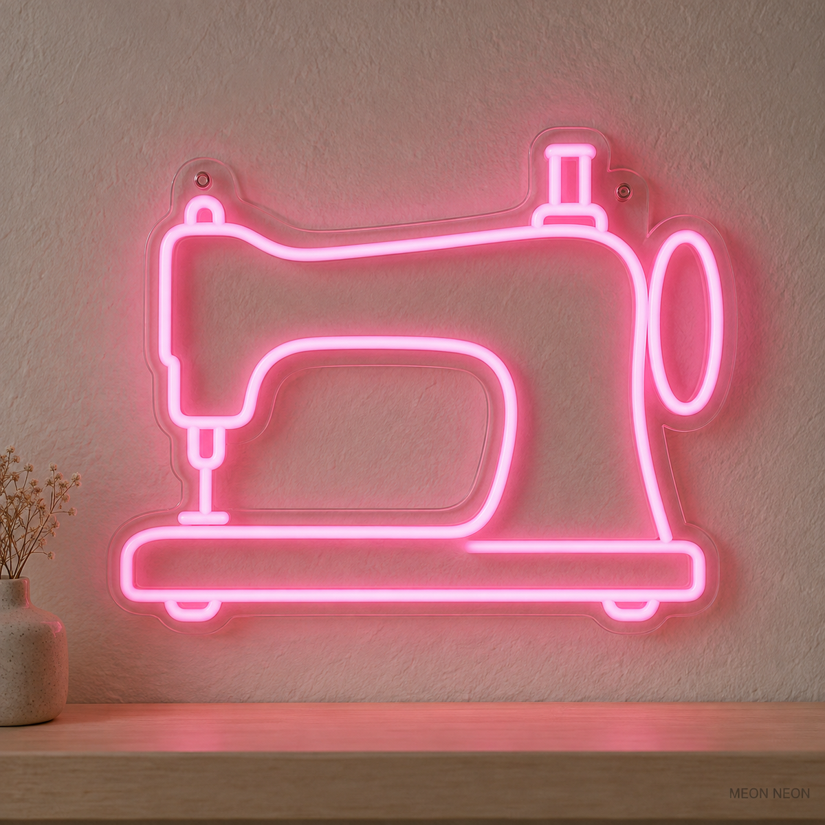 Watermarked concept mockup of Mini Sewing Machine LED Neon Sign in Pink on a clear acrylic backboard.