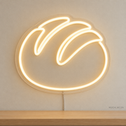 Watermarked concept mockup of Mini Sourdough Loaf LED Neon Sign in Warm White on a clear acrylic backboard.