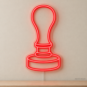 Watermarked concept mockup of Mini Wax Seal Stamp LED Neon Sign in Red on a clear acrylic backboard.