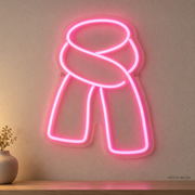 Watermarked concept mockup of Mini Winter Scarf LED Neon Sign in Pink on a clear acrylic backboard.