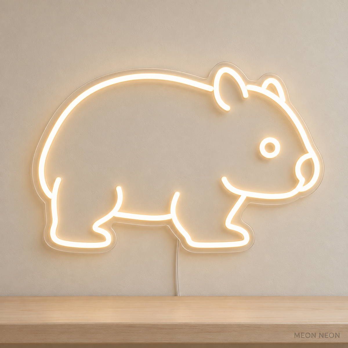 Watermarked concept mockup of Mini Wombat LED Neon Sign in Warm White on a clear acrylic backboard.